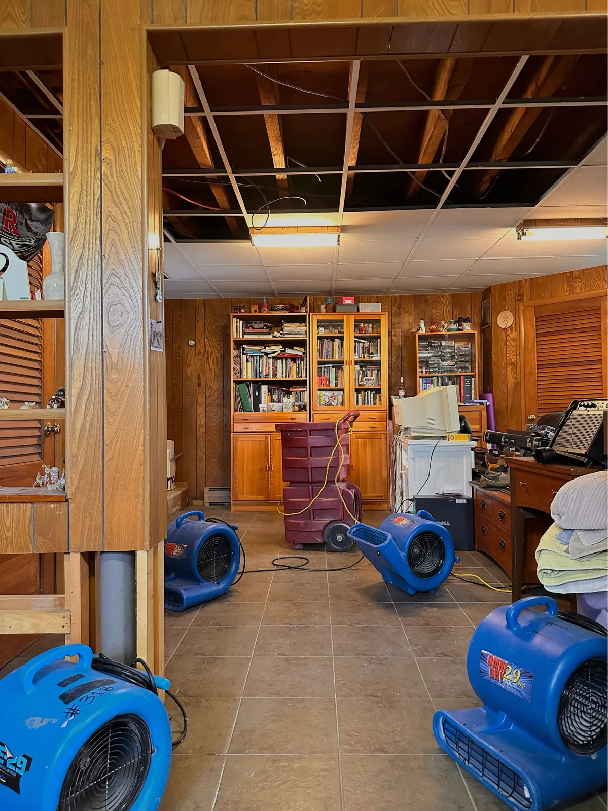 Air movers positioned to dry a finished basement after water damage